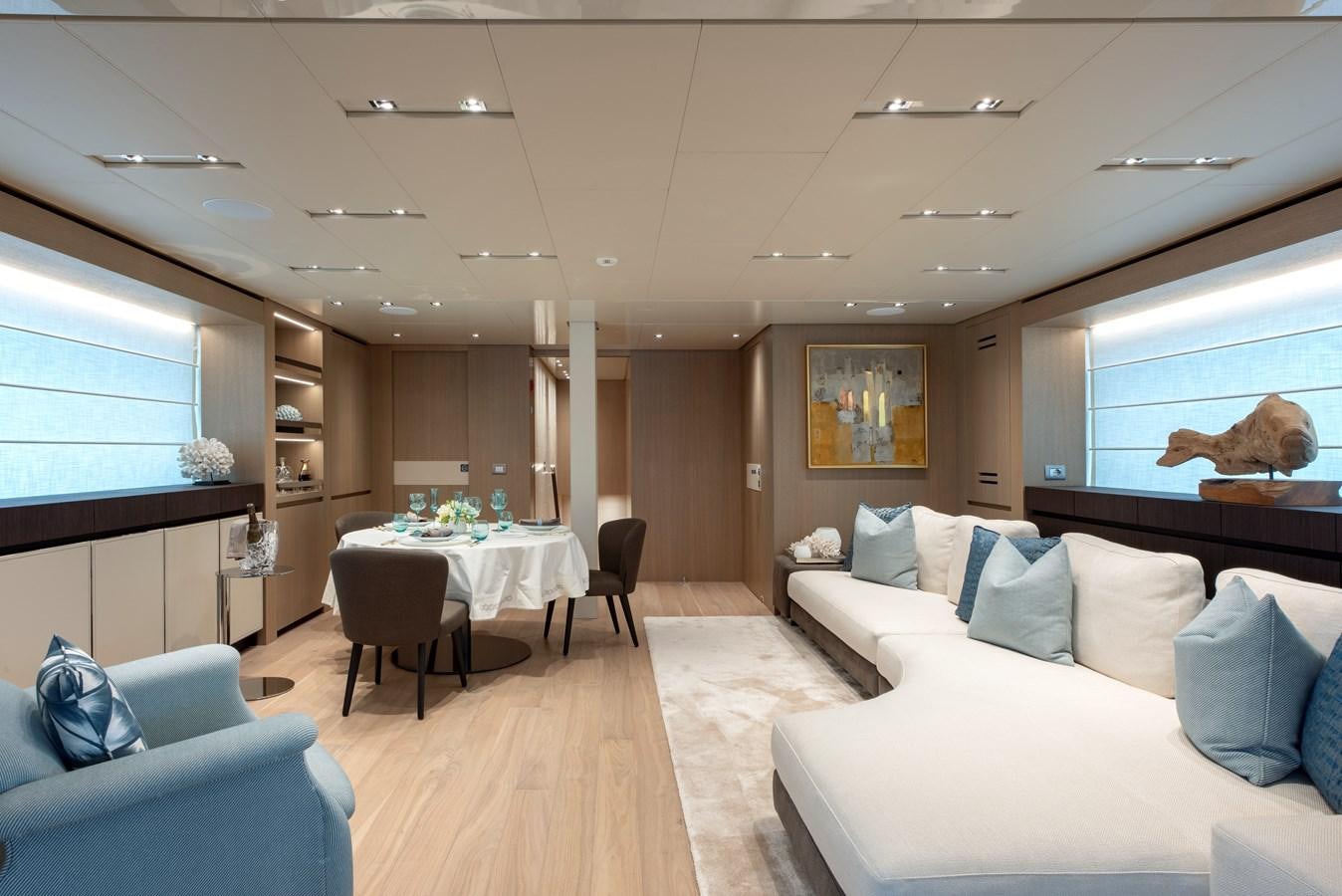 a living room with a couch and a table aboard INSIEME Yacht for Sale