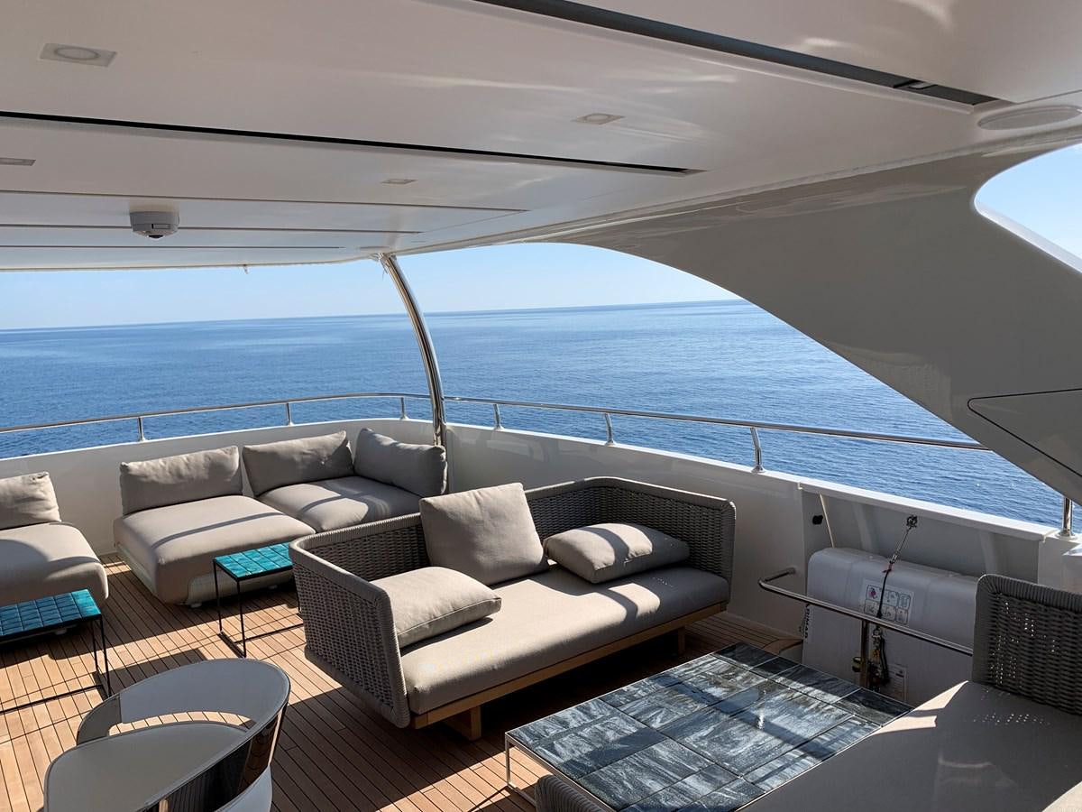 a couch and a table on a boat aboard INSIEME Yacht for Sale