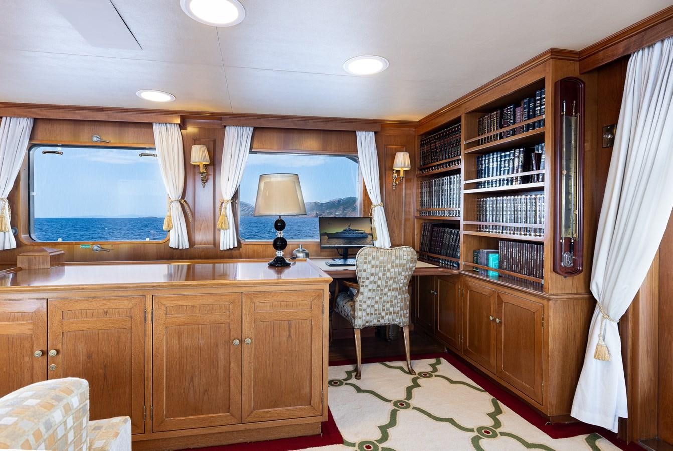 a room with a bookcase and a desk aboard GIN TONIC Yacht for Sale