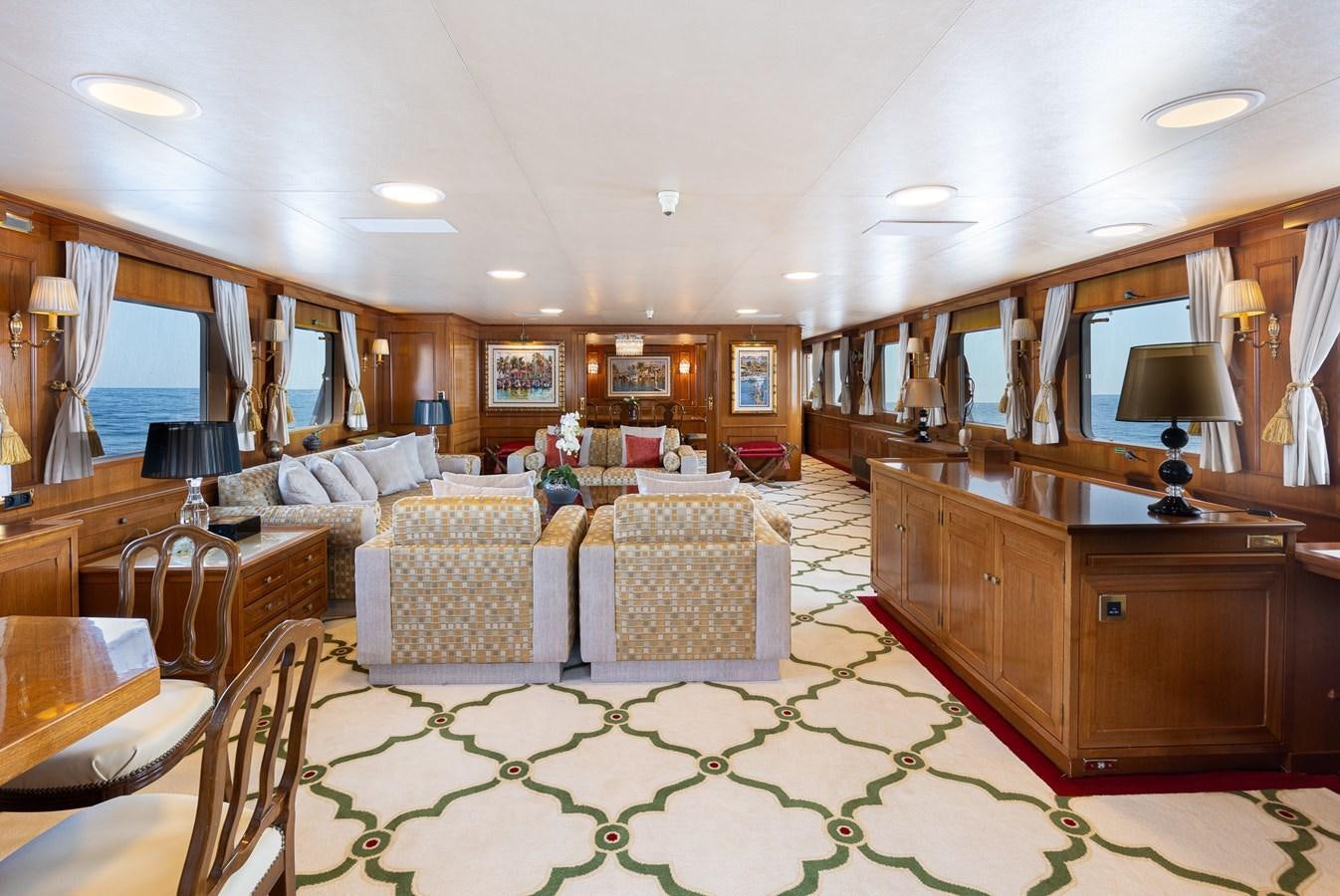 a living room with a large green rug aboard GIN TONIC Yacht for Sale