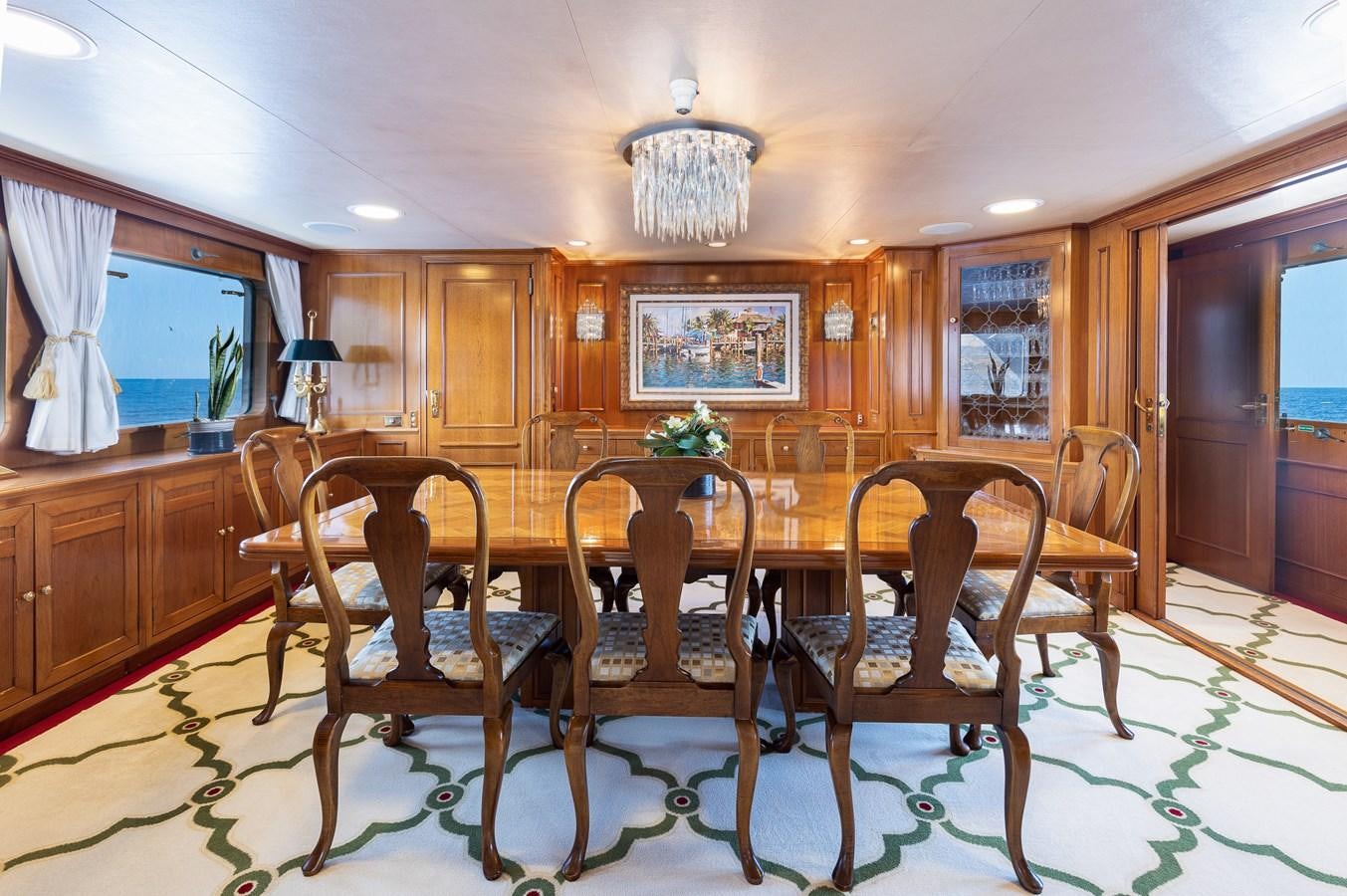 a dining table and chairs in a kitchen aboard GIN TONIC Yacht for Sale