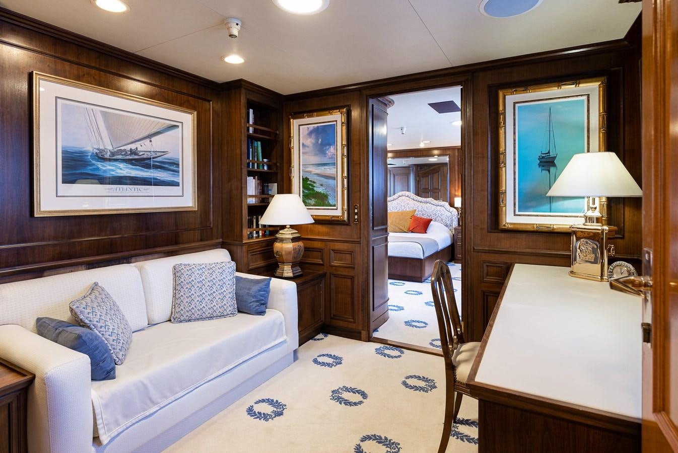 a bedroom with a bed and a desk aboard GIN TONIC Yacht for Sale