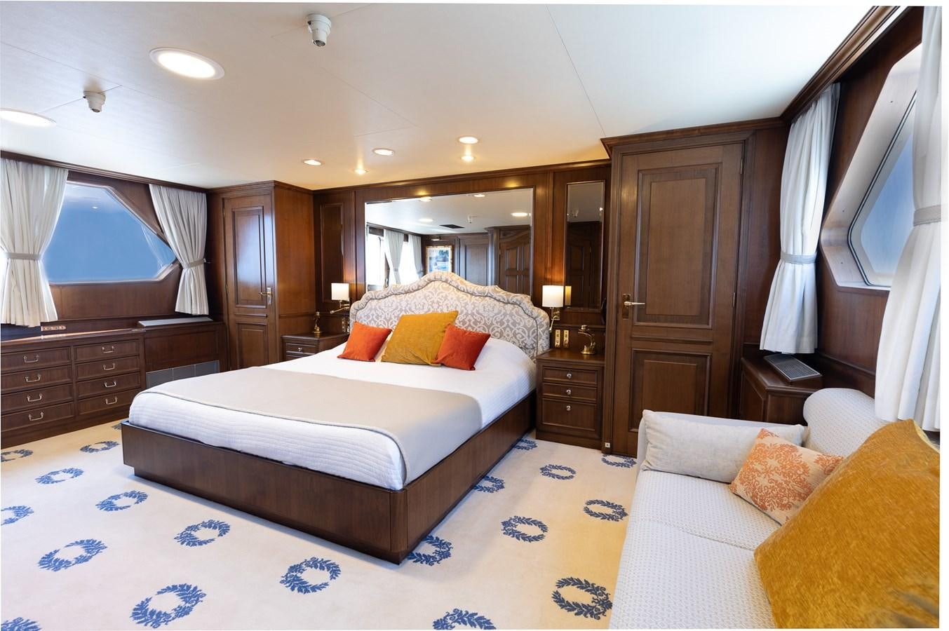 a bedroom with a bed and a mirror aboard GIN TONIC Yacht for Sale