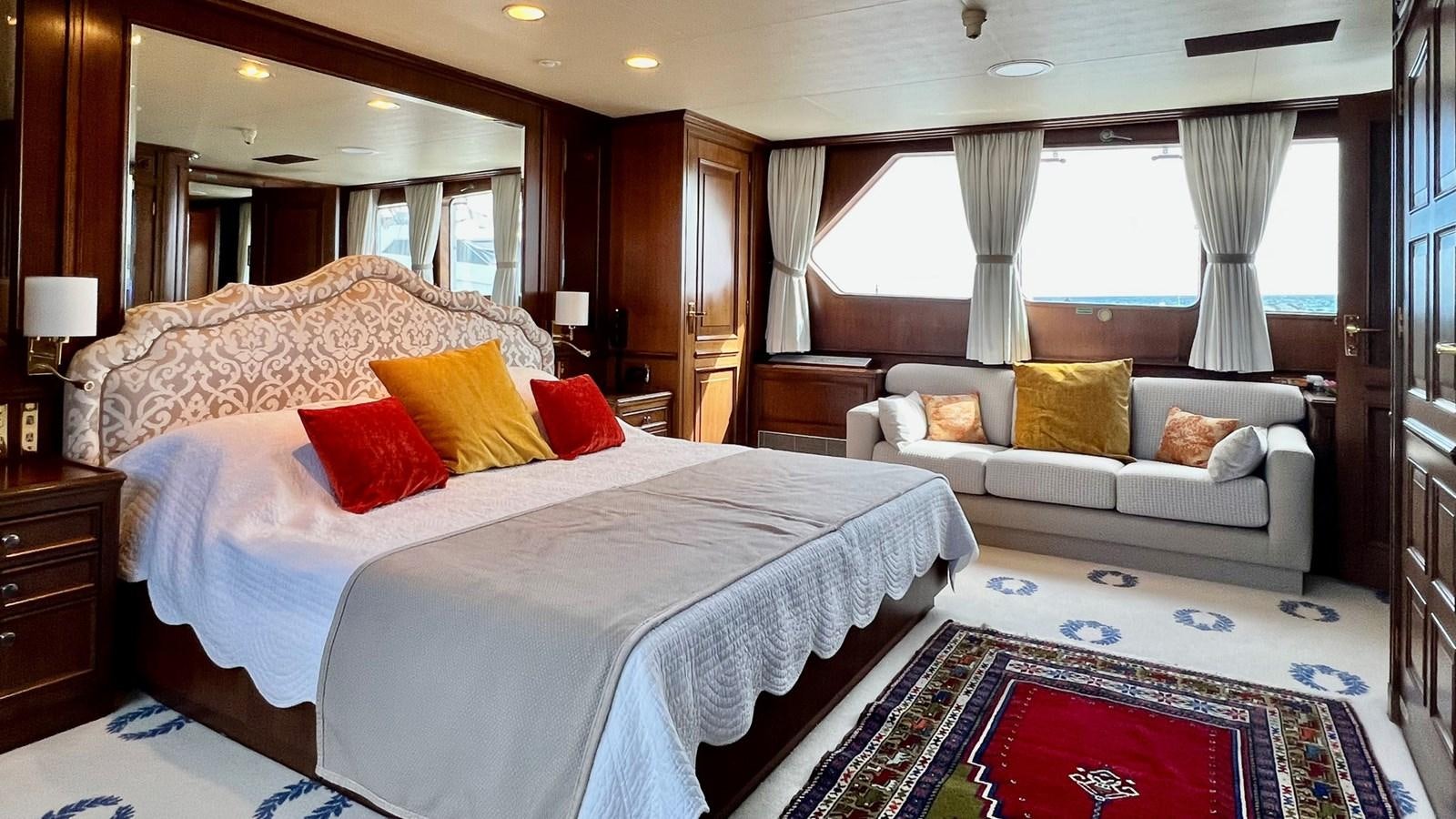 a bedroom with a bed and a couch aboard GIN TONIC Yacht for Sale