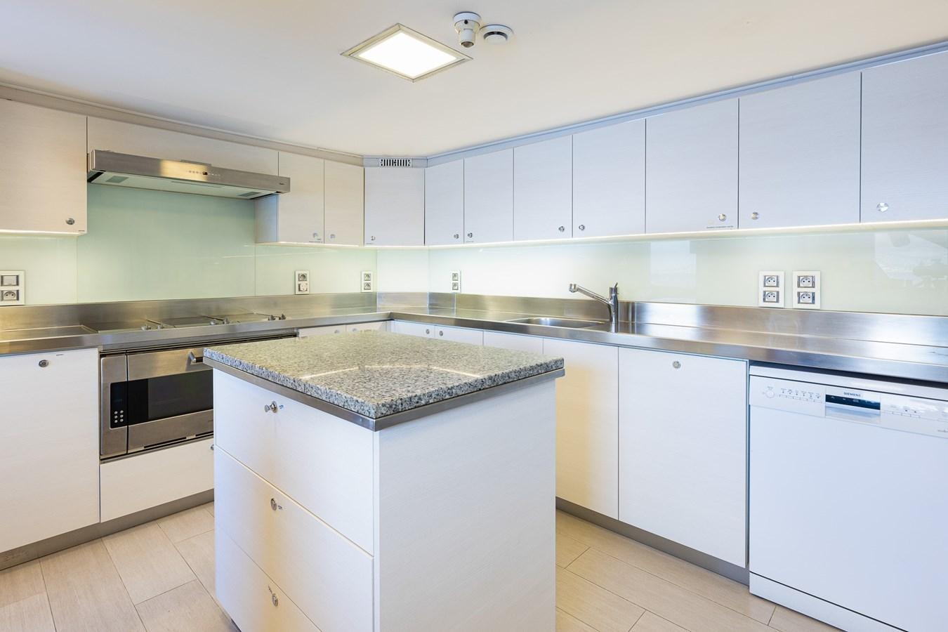 a kitchen with white cabinets aboard GIN TONIC Yacht for Sale