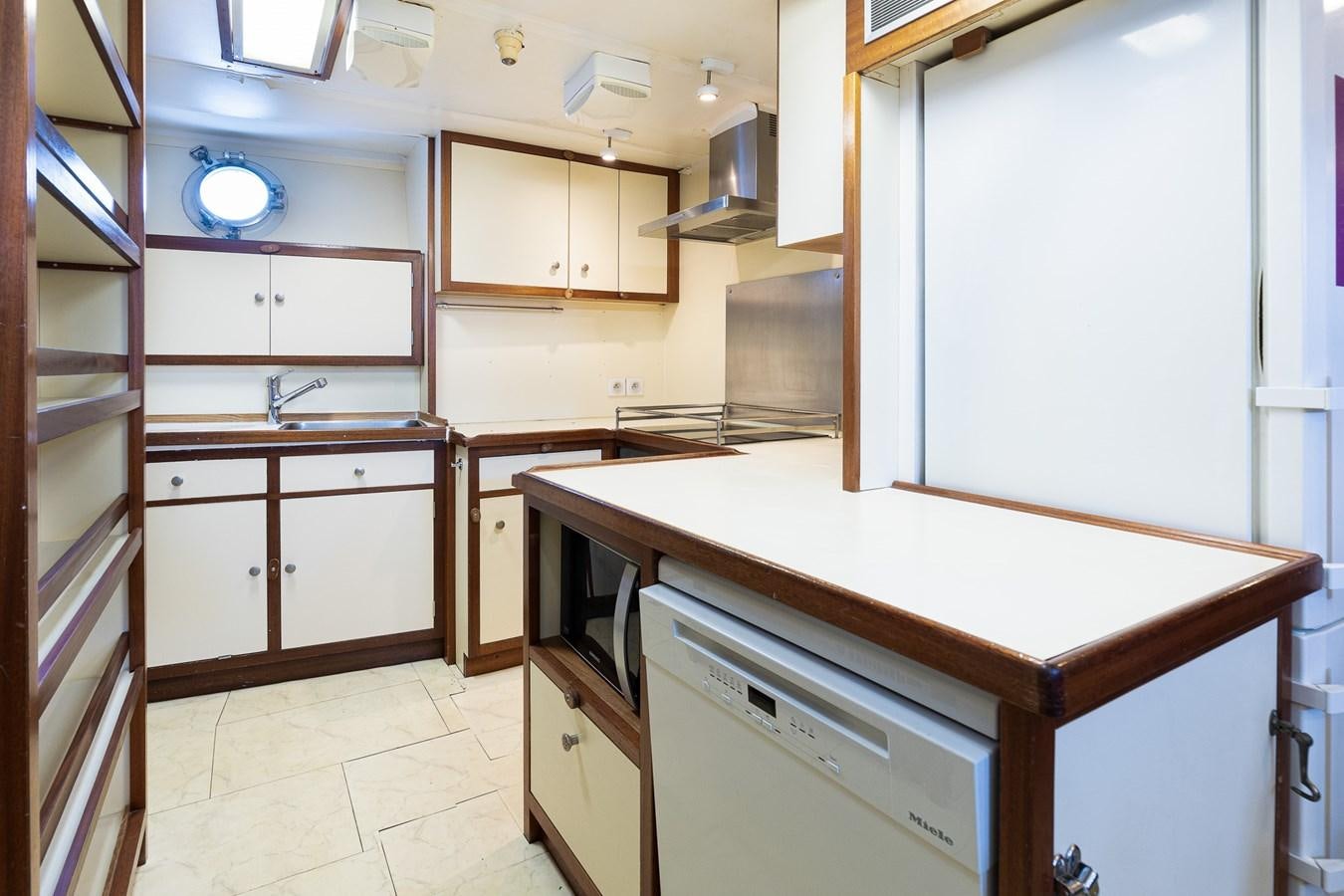 a kitchen with white cabinets aboard GIN TONIC Yacht for Sale