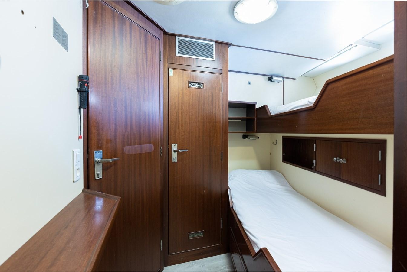 a room with a bed and a closet aboard GIN TONIC Yacht for Sale