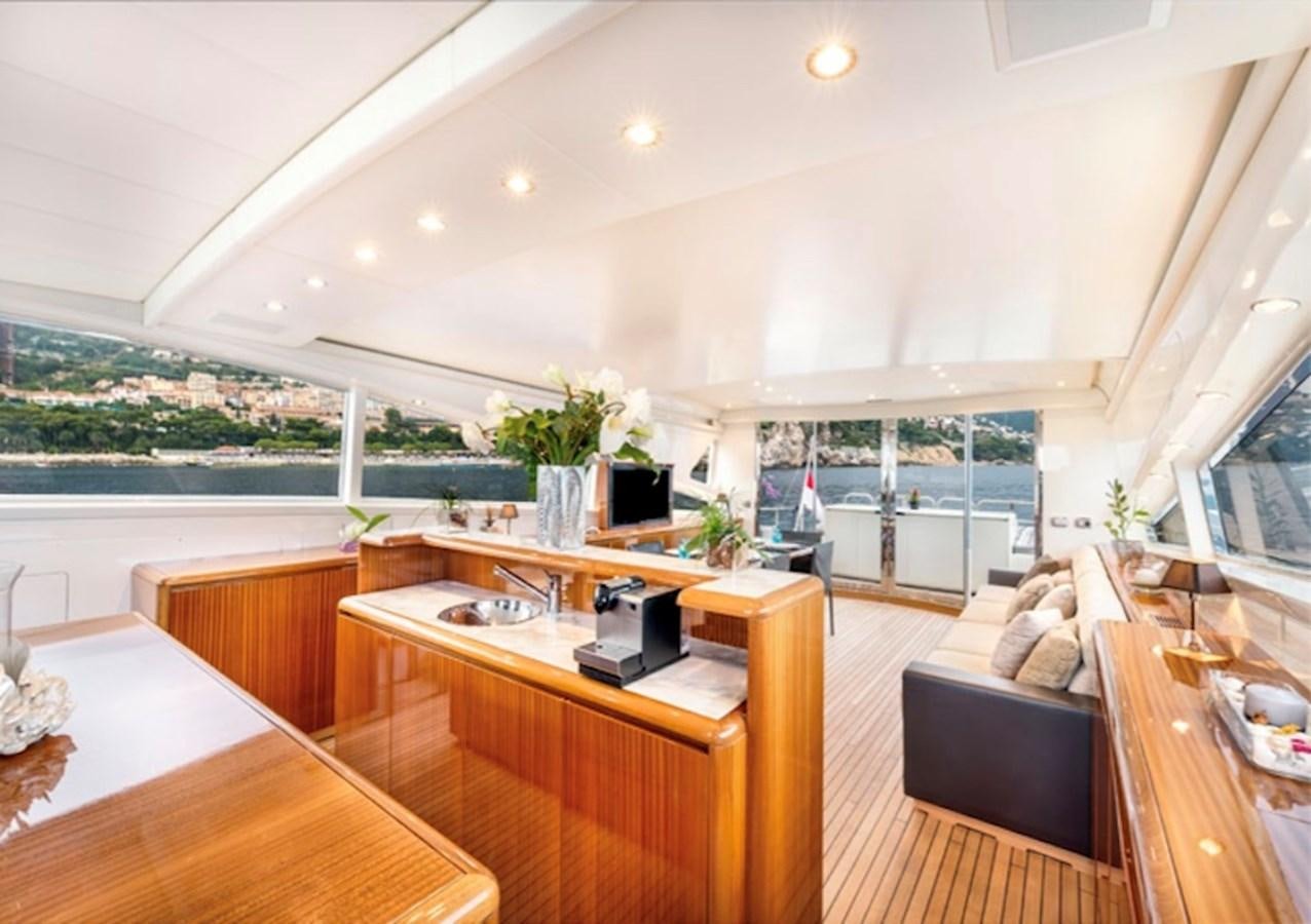 a room with a wood table and a laptop on a desk aboard LEOPARD 27M Yacht for Sale