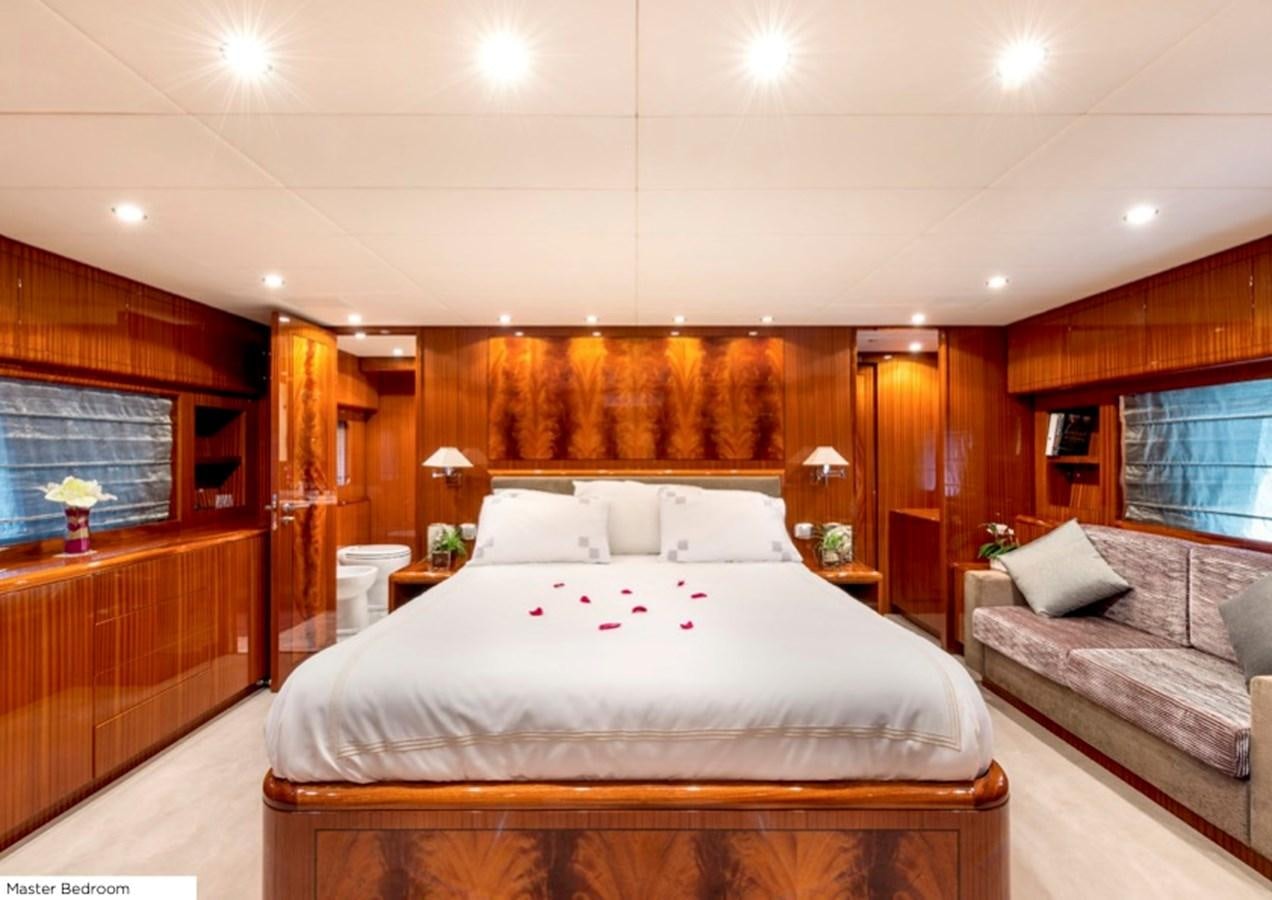 a bedroom with a bed and a couch aboard LEOPARD 27M Yacht for Sale