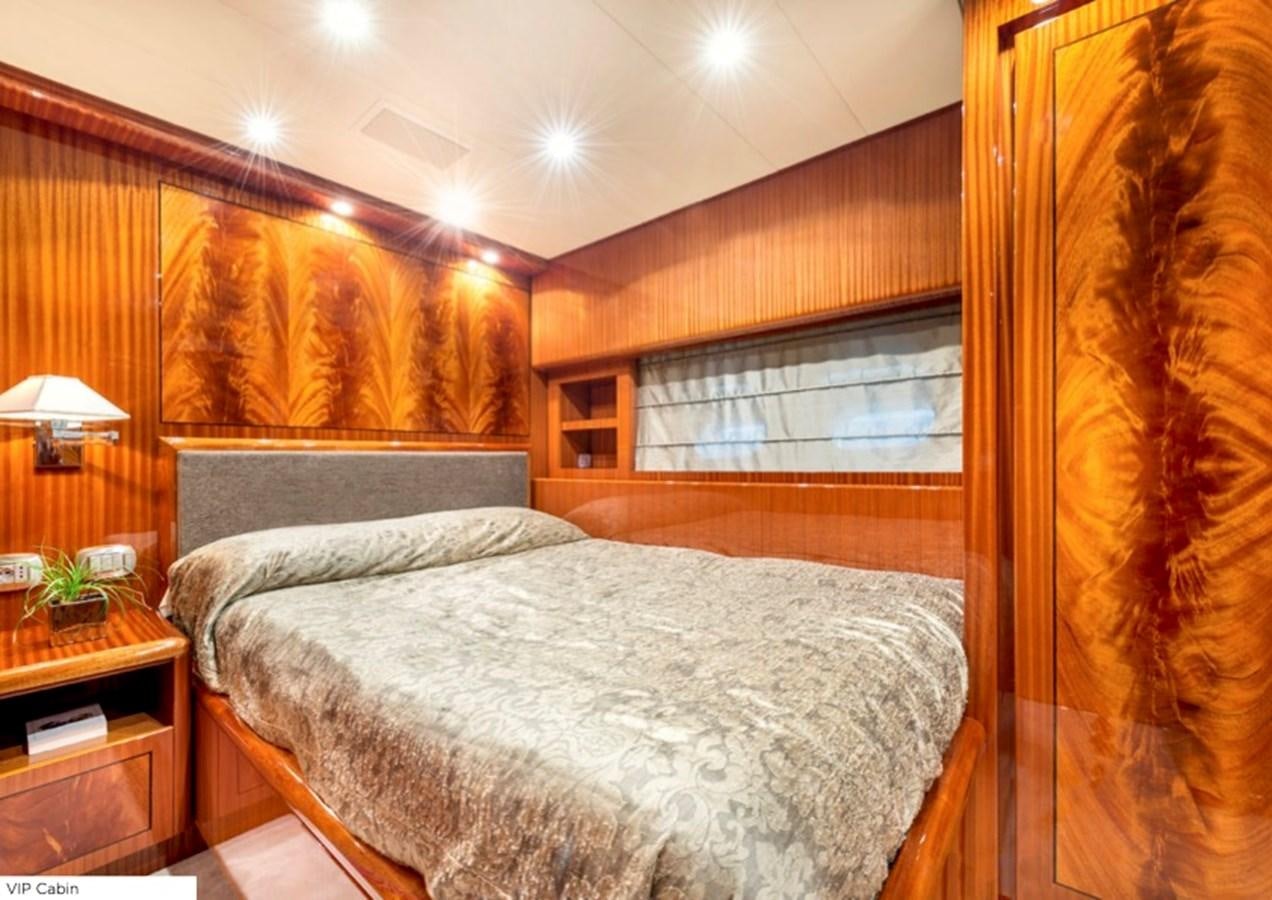 a bedroom with a bed and a window aboard LEOPARD 27M Yacht for Sale