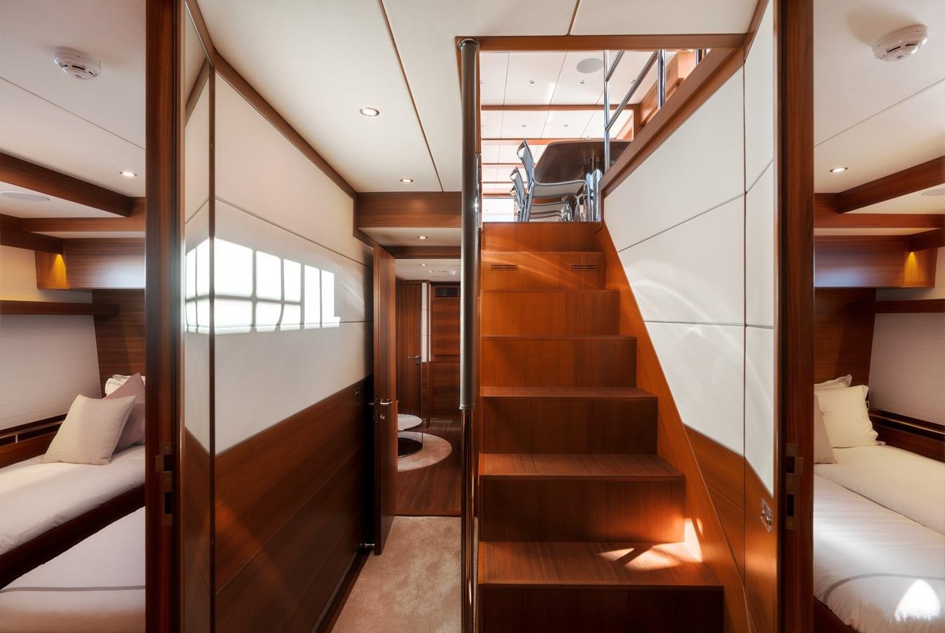 a room with wooden stairs aboard SHOCKWAVE Yacht for Sale