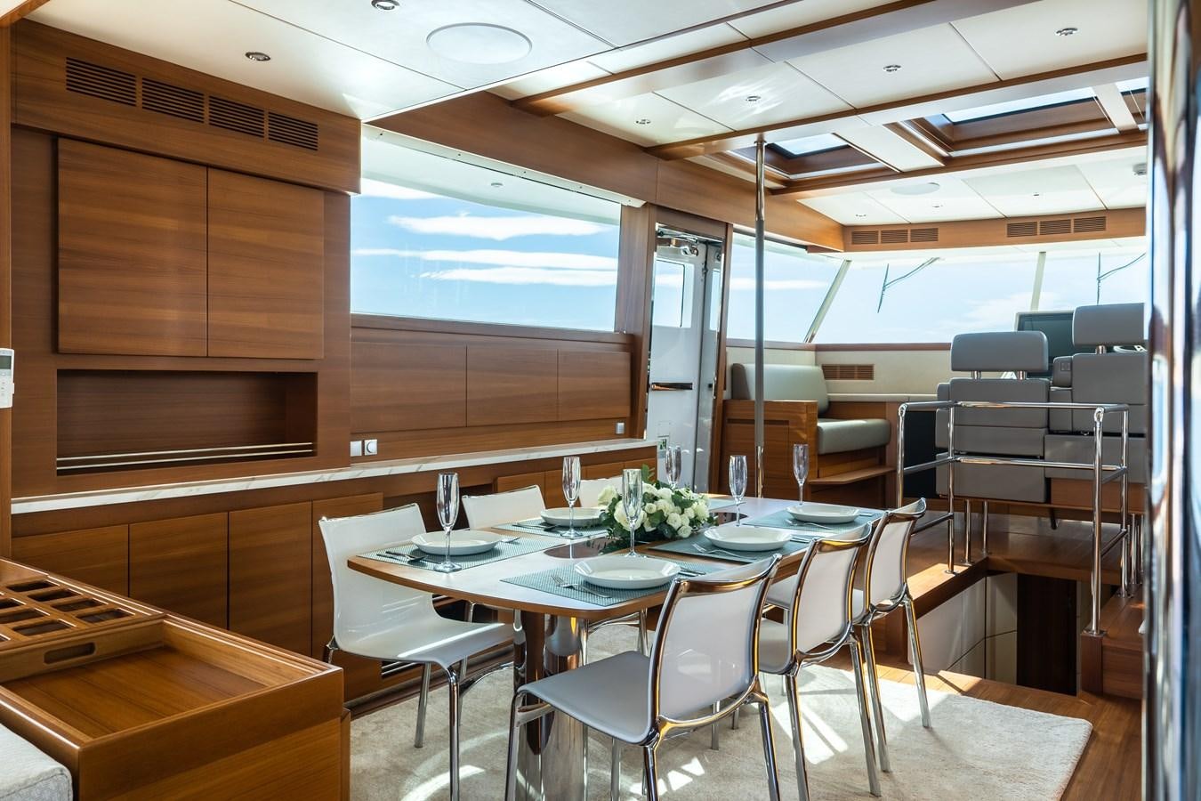 a room with tables and chairs aboard SHOCKWAVE Yacht for Sale