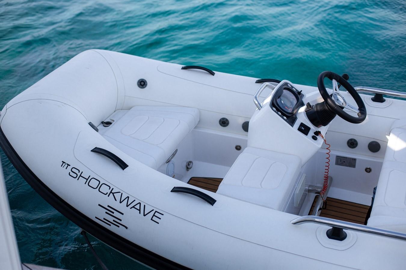 a white speed boat with a black handle aboard SHOCKWAVE Yacht for Sale