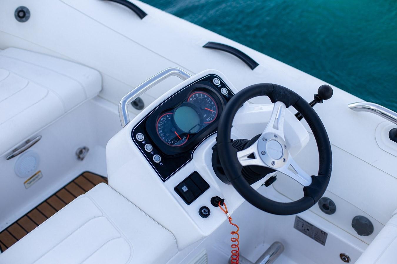a close-up of a steering wheel aboard SHOCKWAVE Yacht for Sale