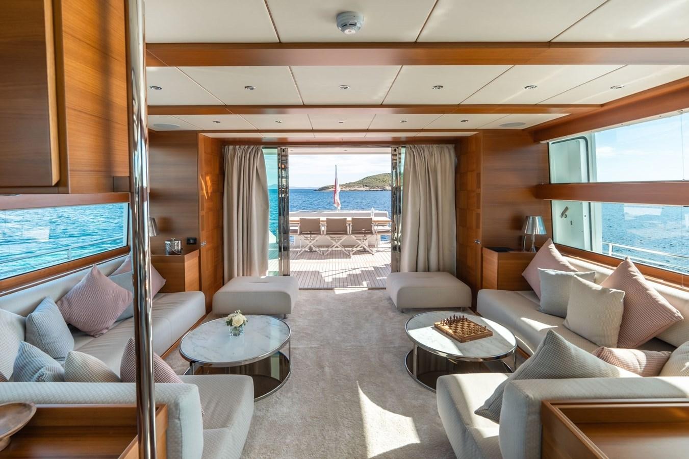 a room with a couch and a table and a window aboard SHOCKWAVE Yacht for Sale