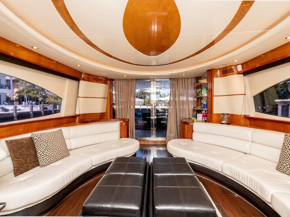 a room with couches and a table and a large mirror aboard NUEVA OLA Yacht for Sale