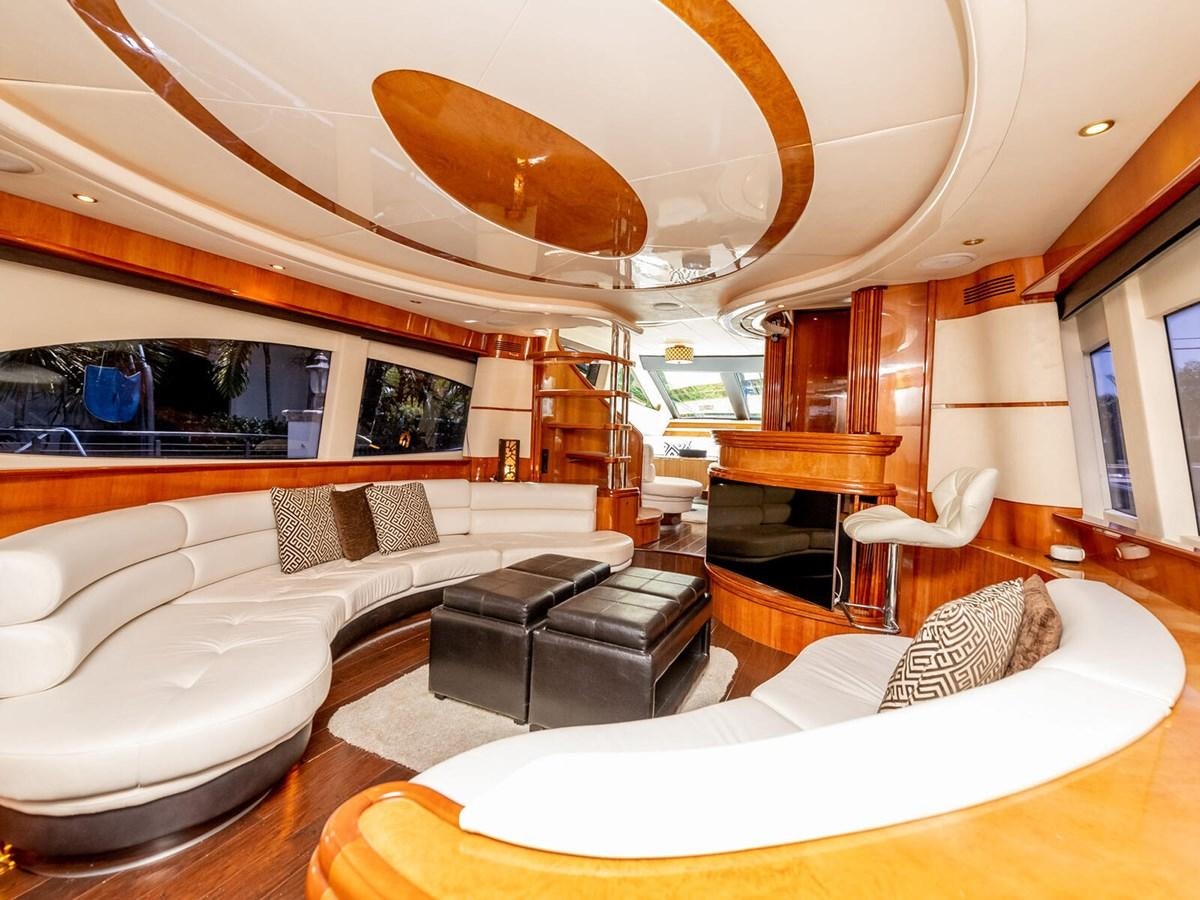 a large living room with a large mirror above the couch aboard NUEVA OLA Yacht for Sale