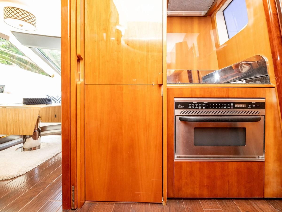 a kitchen with wooden cabinets aboard NUEVA OLA Yacht for Sale