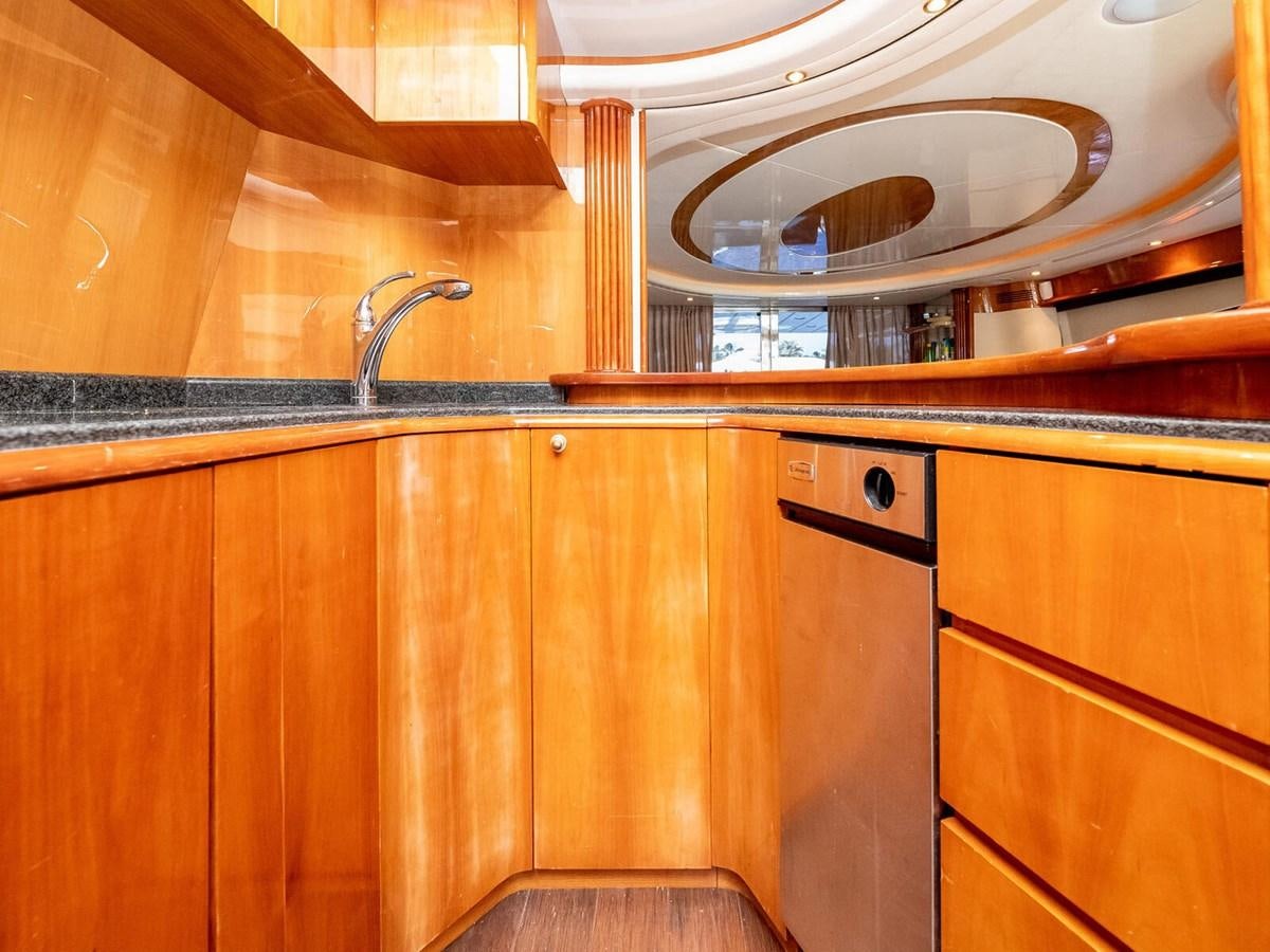 a kitchen with wooden cabinets aboard NUEVA OLA Yacht for Sale