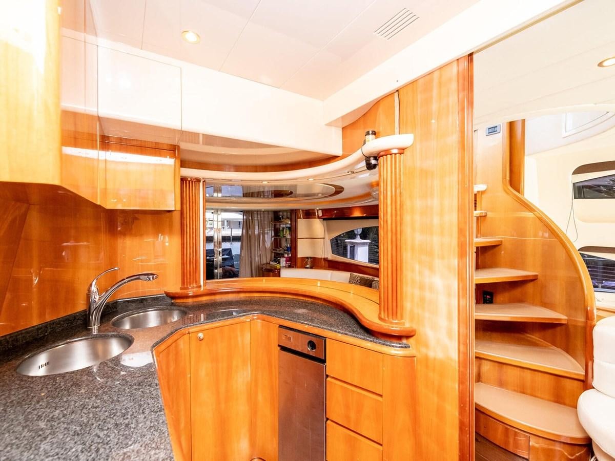 a kitchen with wooden cabinets aboard NUEVA OLA Yacht for Sale