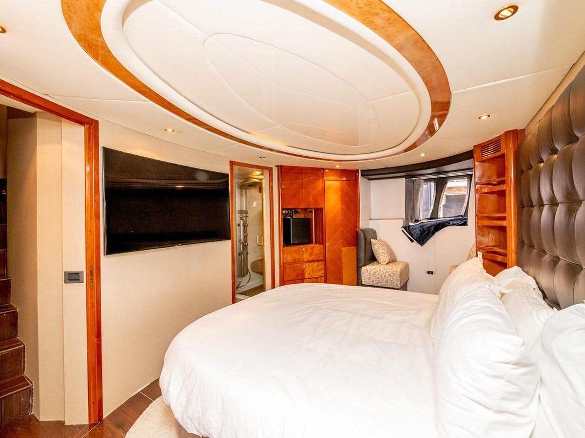 a bedroom with a bed and a mirror aboard NUEVA OLA Yacht for Sale