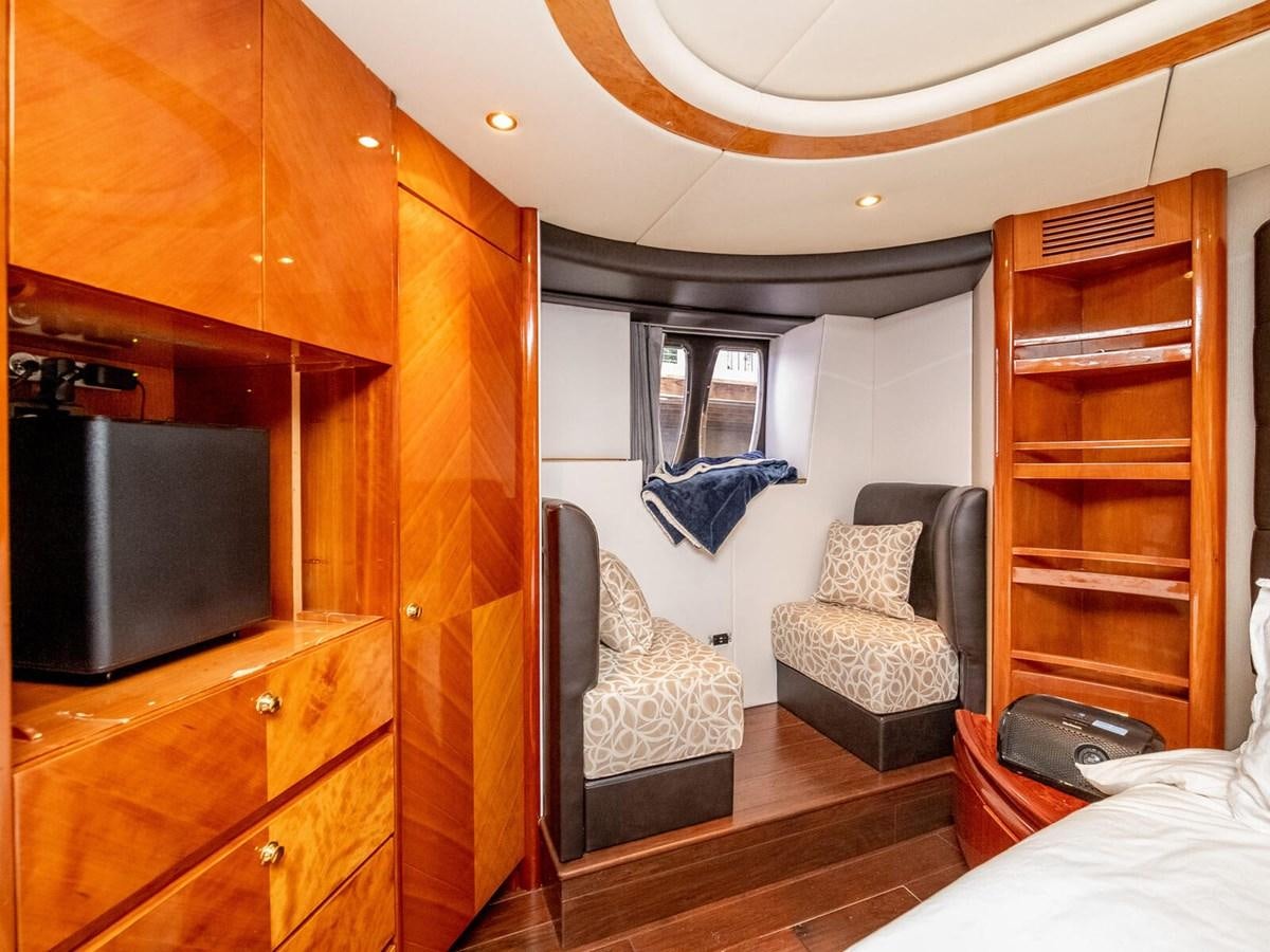 a living room with a wood cabinet aboard NUEVA OLA Yacht for Sale