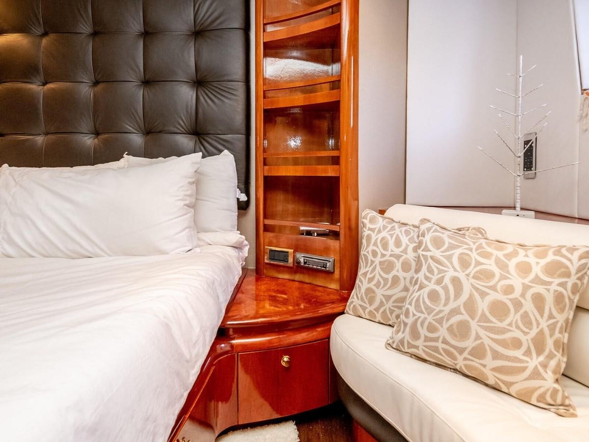 a room with a bed and a dresser aboard NUEVA OLA Yacht for Sale