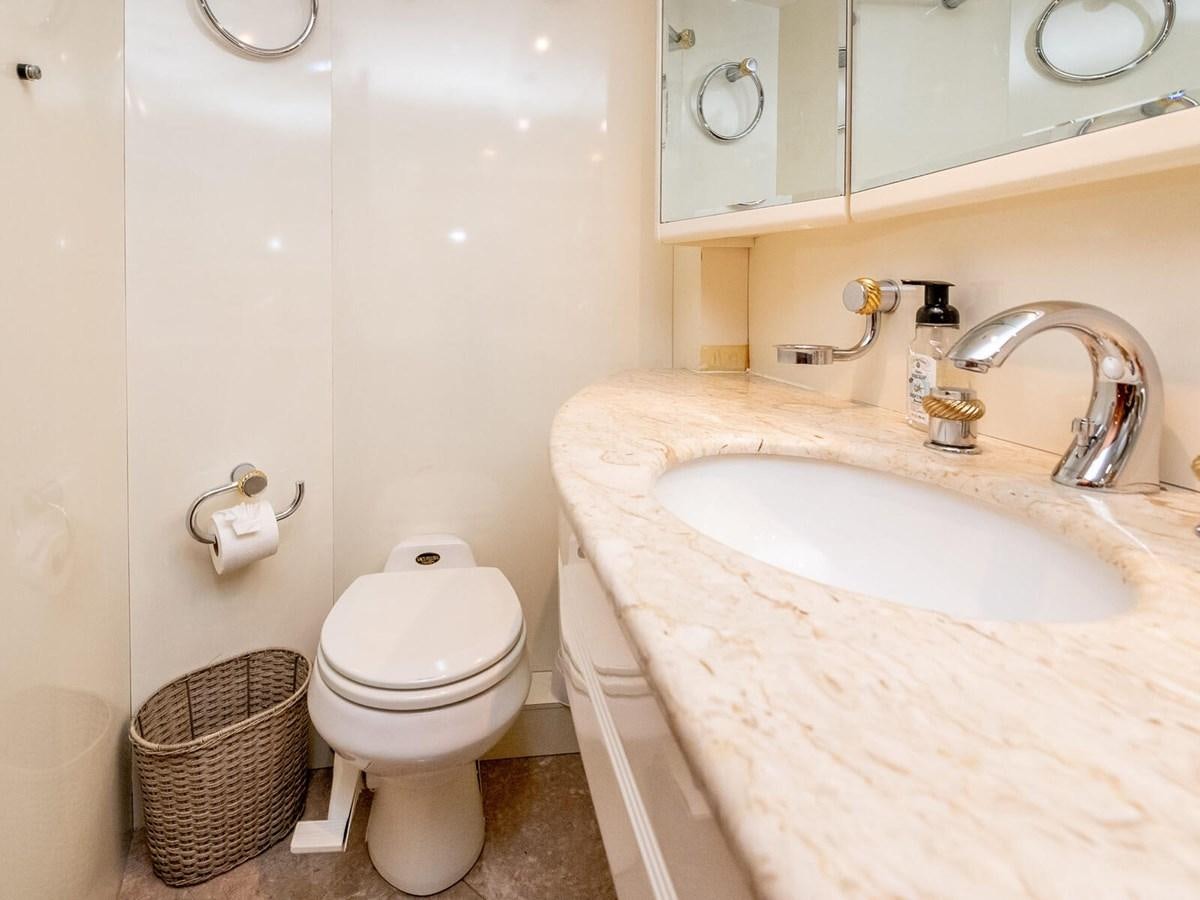 a bathroom with a toilet sink and a mirror aboard NUEVA OLA Yacht for Sale