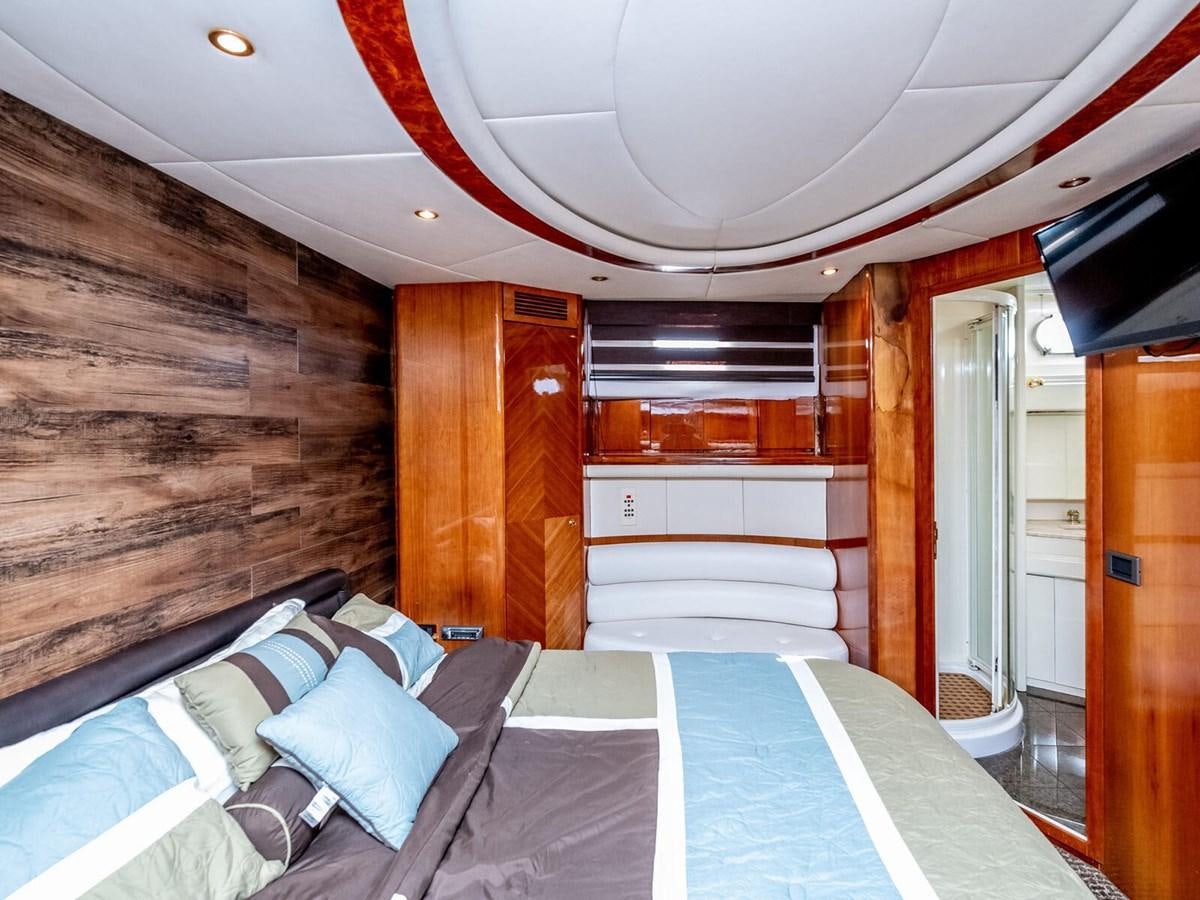 a room with a bed and a wood wall aboard NUEVA OLA Yacht for Sale