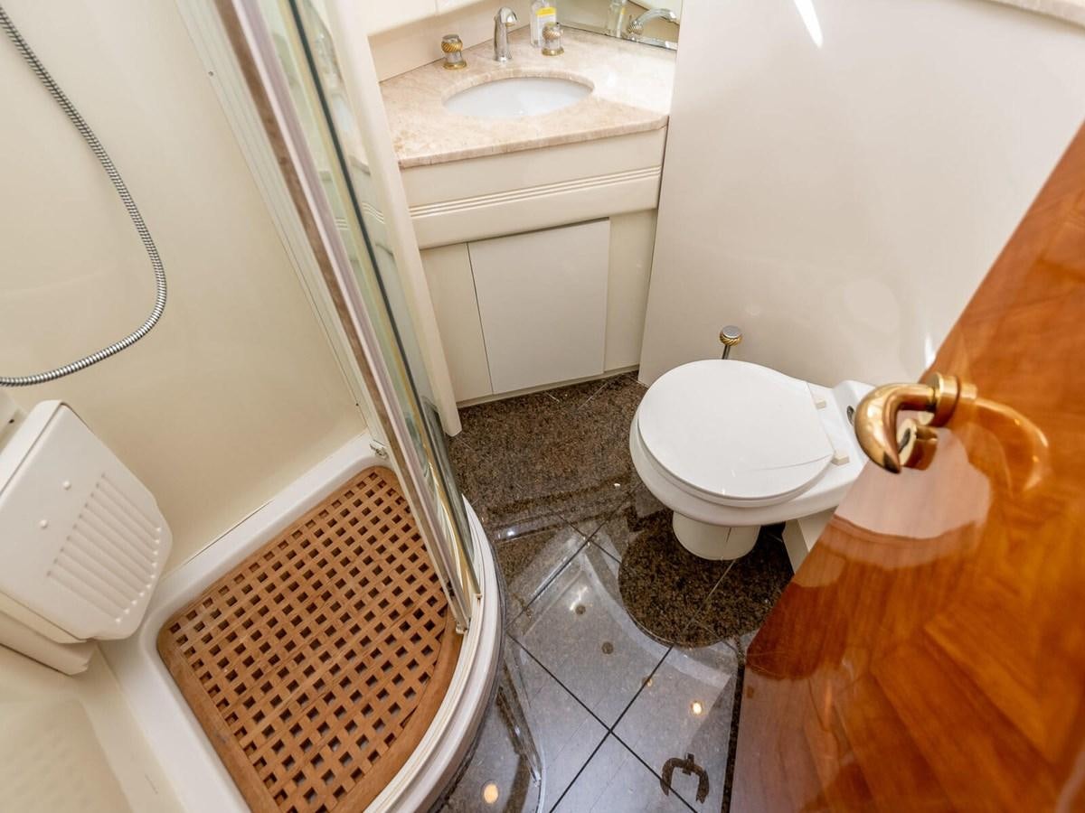 a bathroom with a toilet and sink aboard NUEVA OLA Yacht for Sale