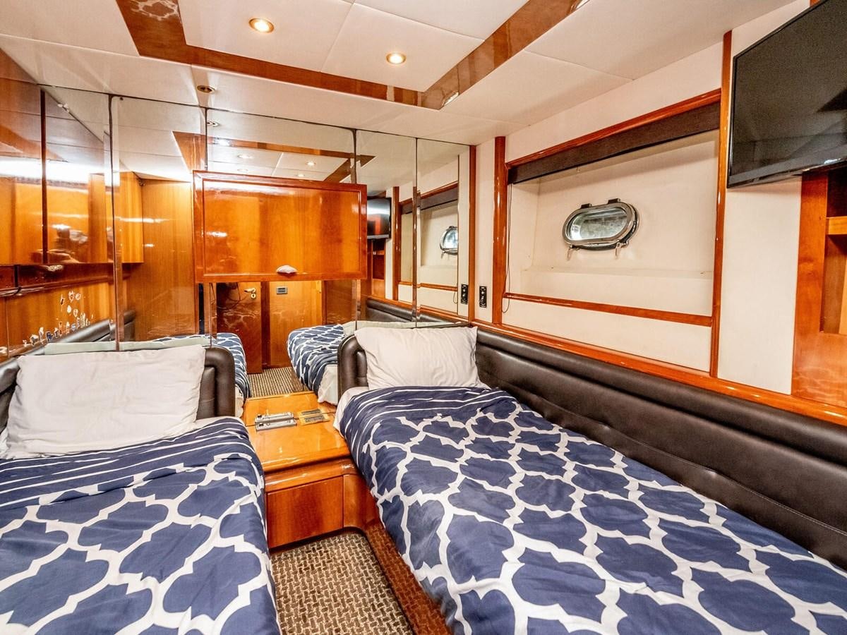 a room with a bed and a mirror aboard NUEVA OLA Yacht for Sale