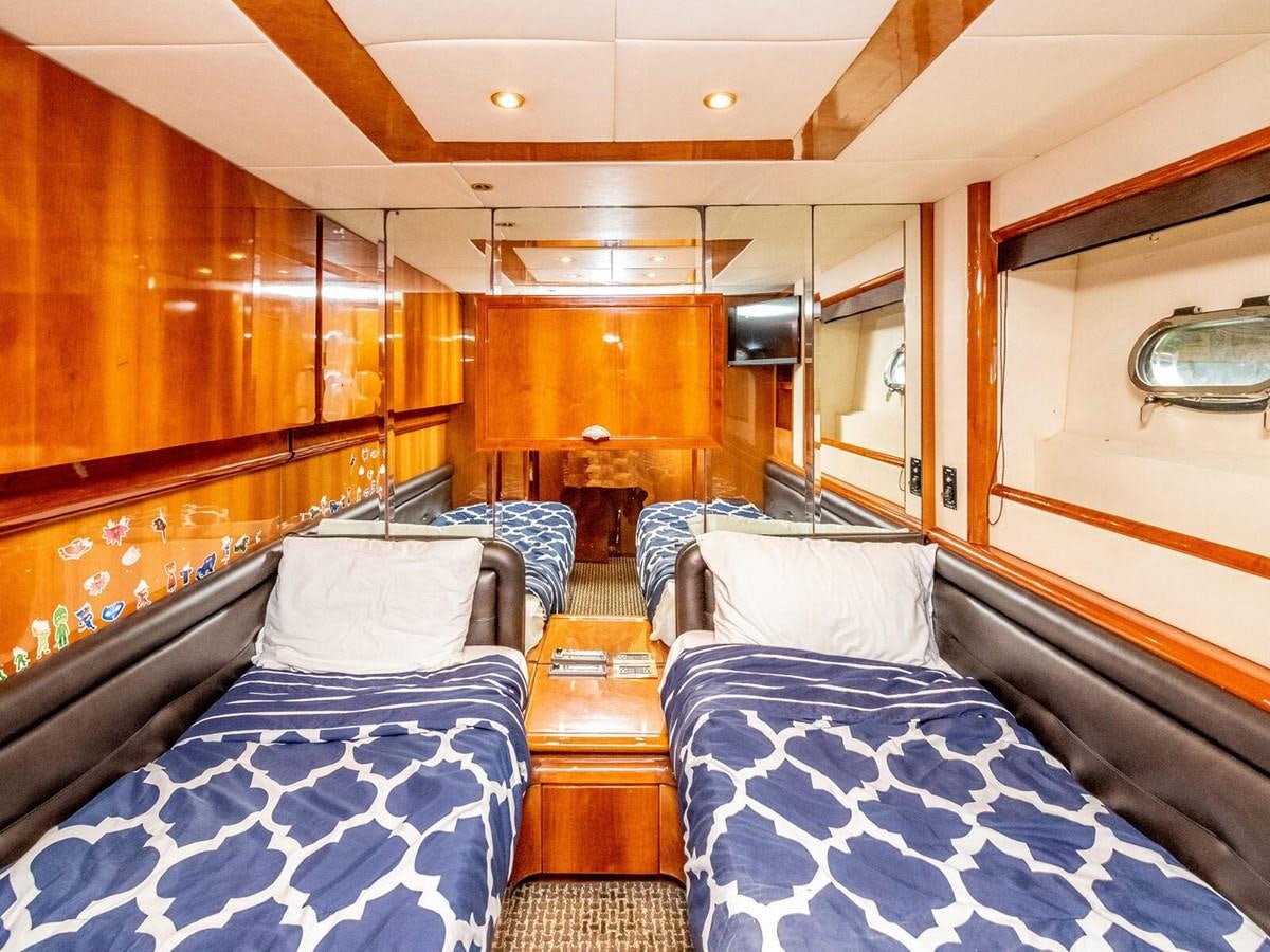a room with a bed and a television aboard NUEVA OLA Yacht for Sale