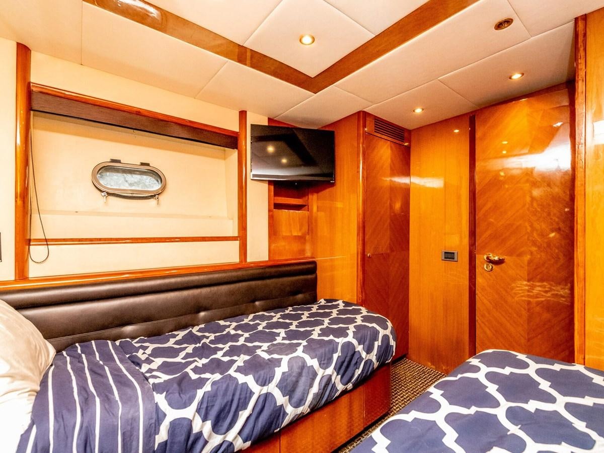 a room with a bed and a television aboard NUEVA OLA Yacht for Sale