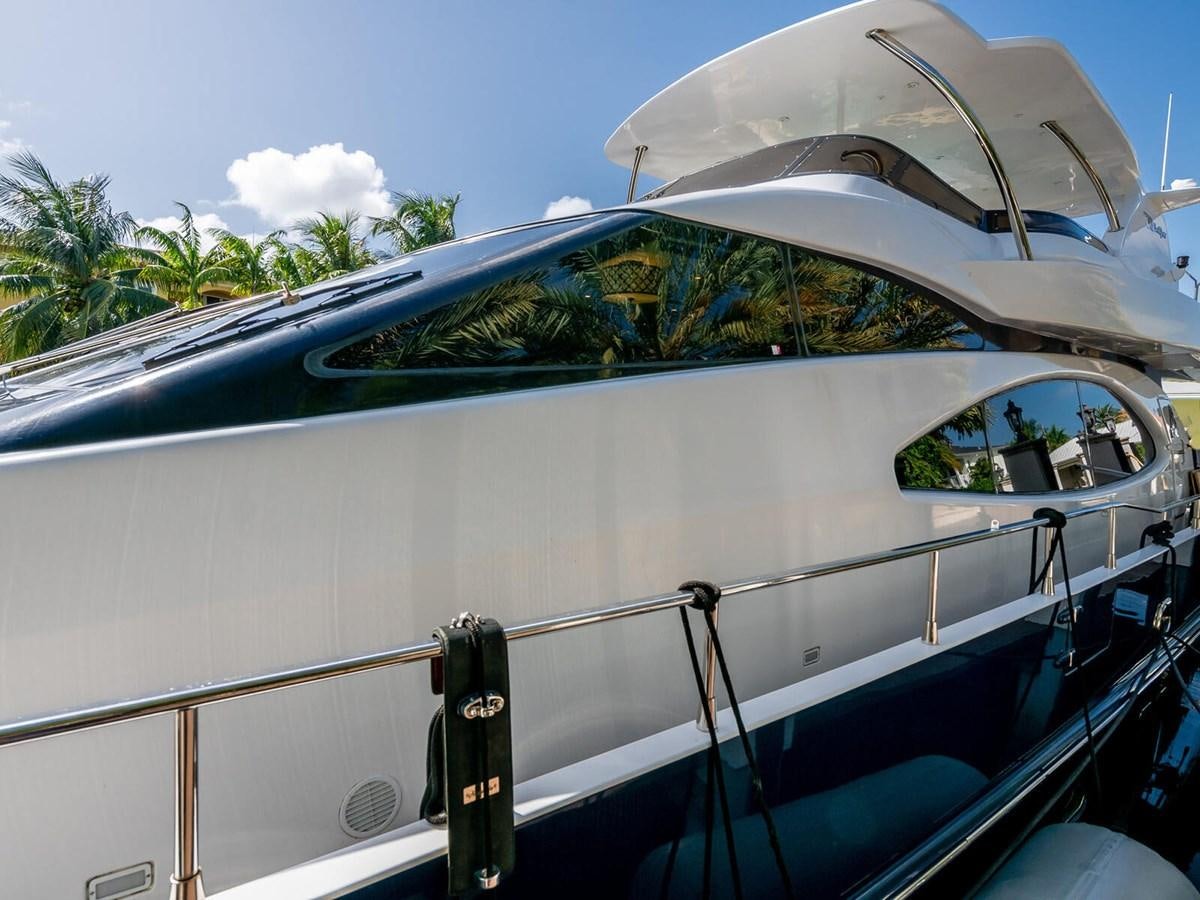 a white boat with a blue canopy aboard NUEVA OLA Yacht for Sale