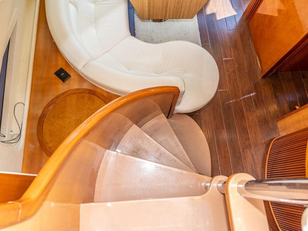 a chair with a couch in the background aboard NUEVA OLA Yacht for Sale
