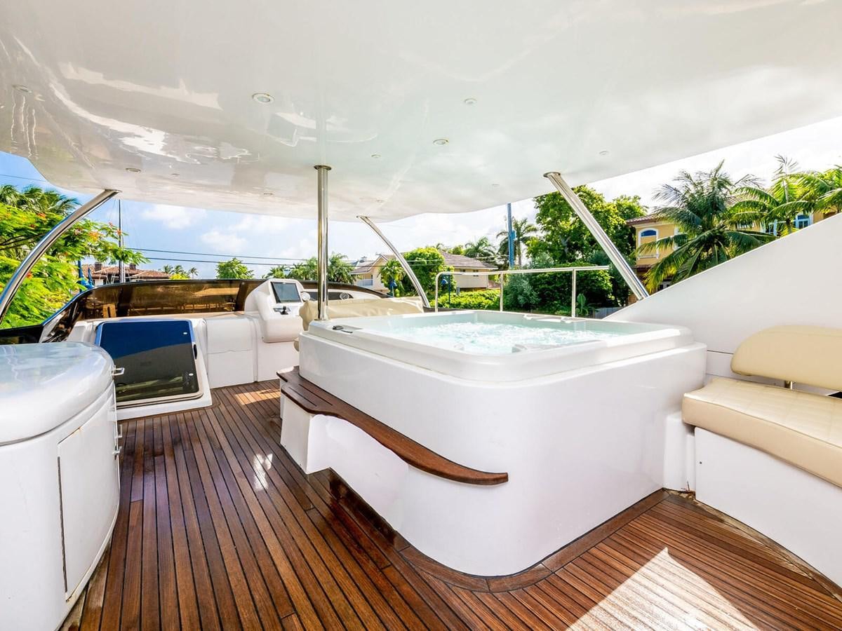 a deck with a pool and a deck with chairs and trees aboard NUEVA OLA Yacht for Sale