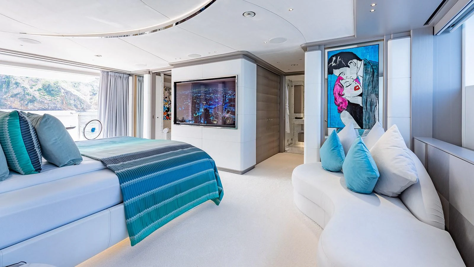 a room with a blue couch and a blue and white striped bed aboard SEAGULL MRD Yacht for Sale