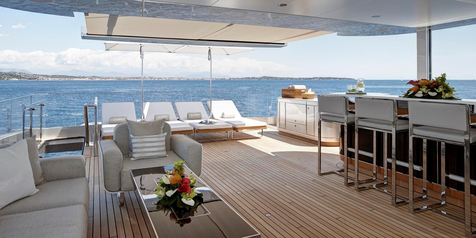 a room with a table chairs and a large body of water aboard EXCELLENCE V Yacht for Sale