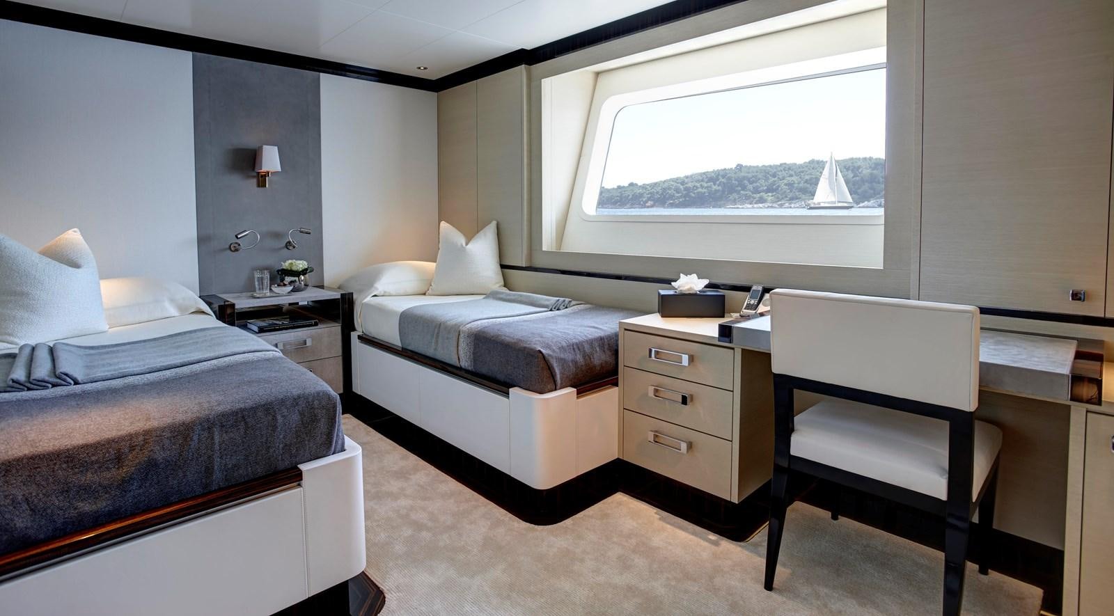 a bedroom with two beds aboard EXCELLENCE V Yacht for Sale