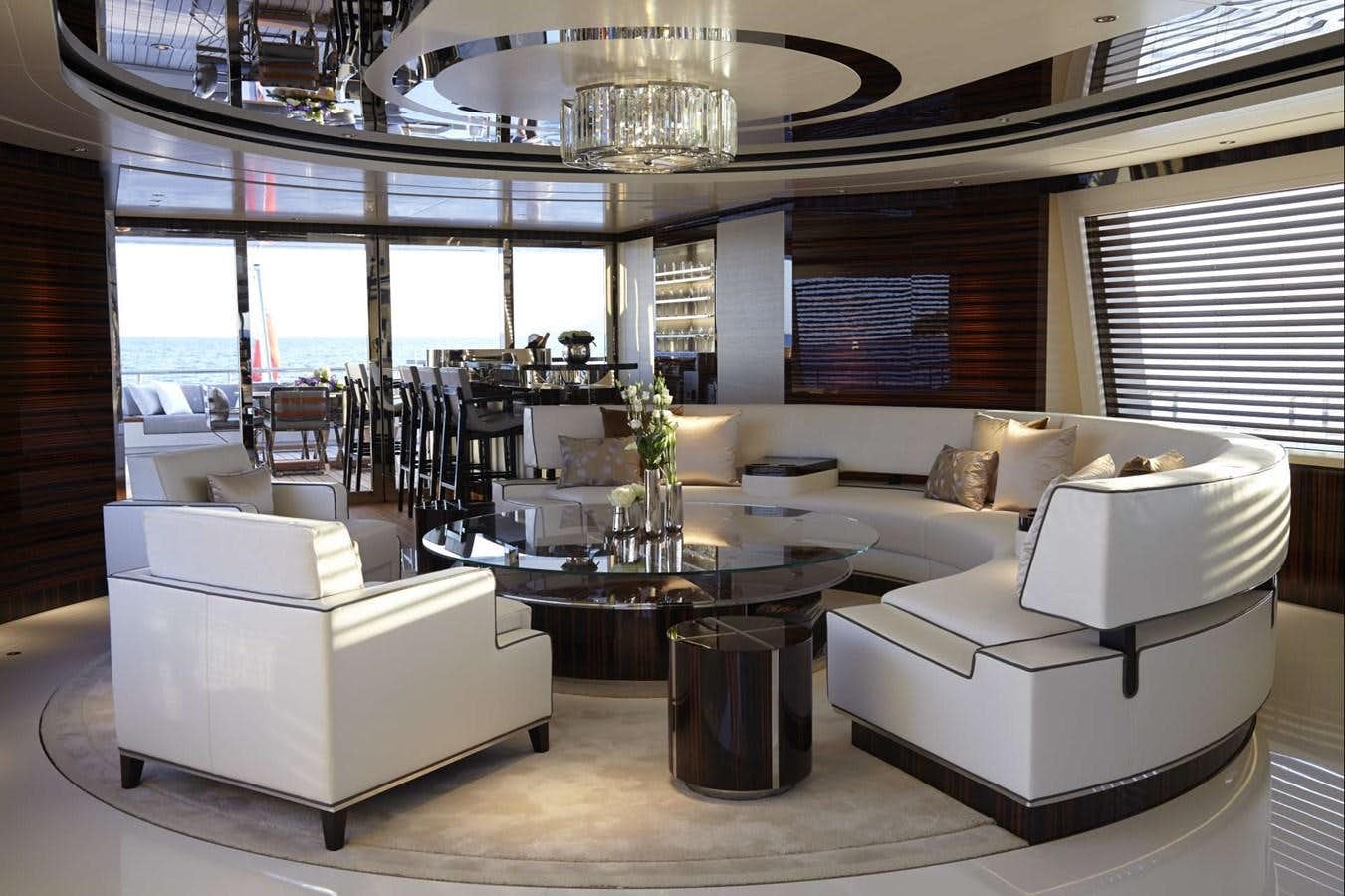 a room with a couch and a table aboard EXCELLENCE V Yacht for Sale