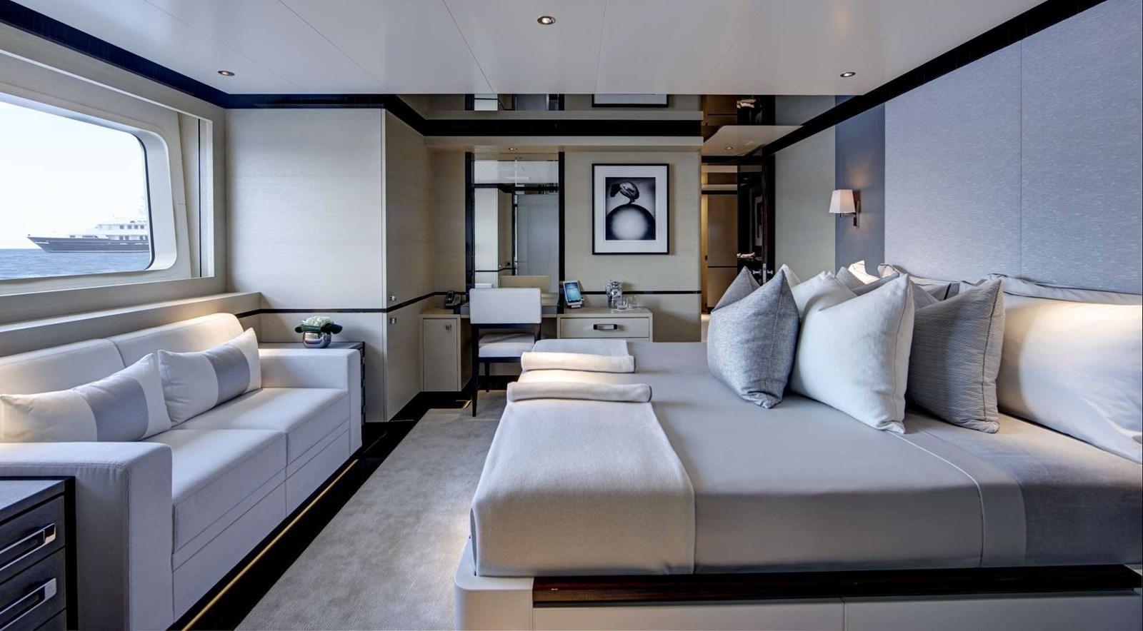 a room with a bed and a couch aboard EXCELLENCE V Yacht for Sale