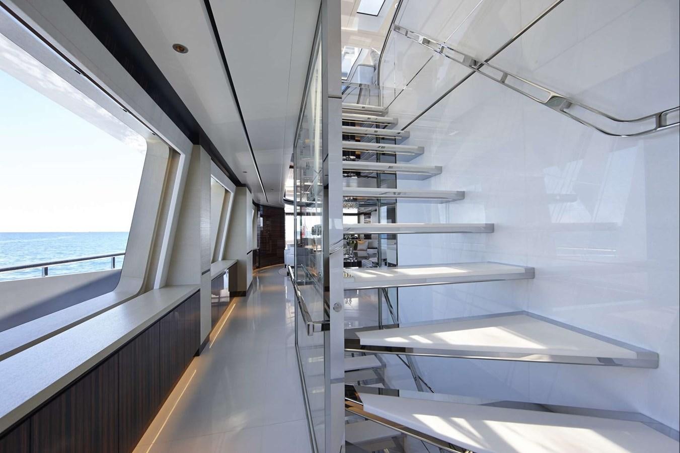 a room with a glass wall and a window with a view of the water aboard EXCELLENCE V Yacht for Sale