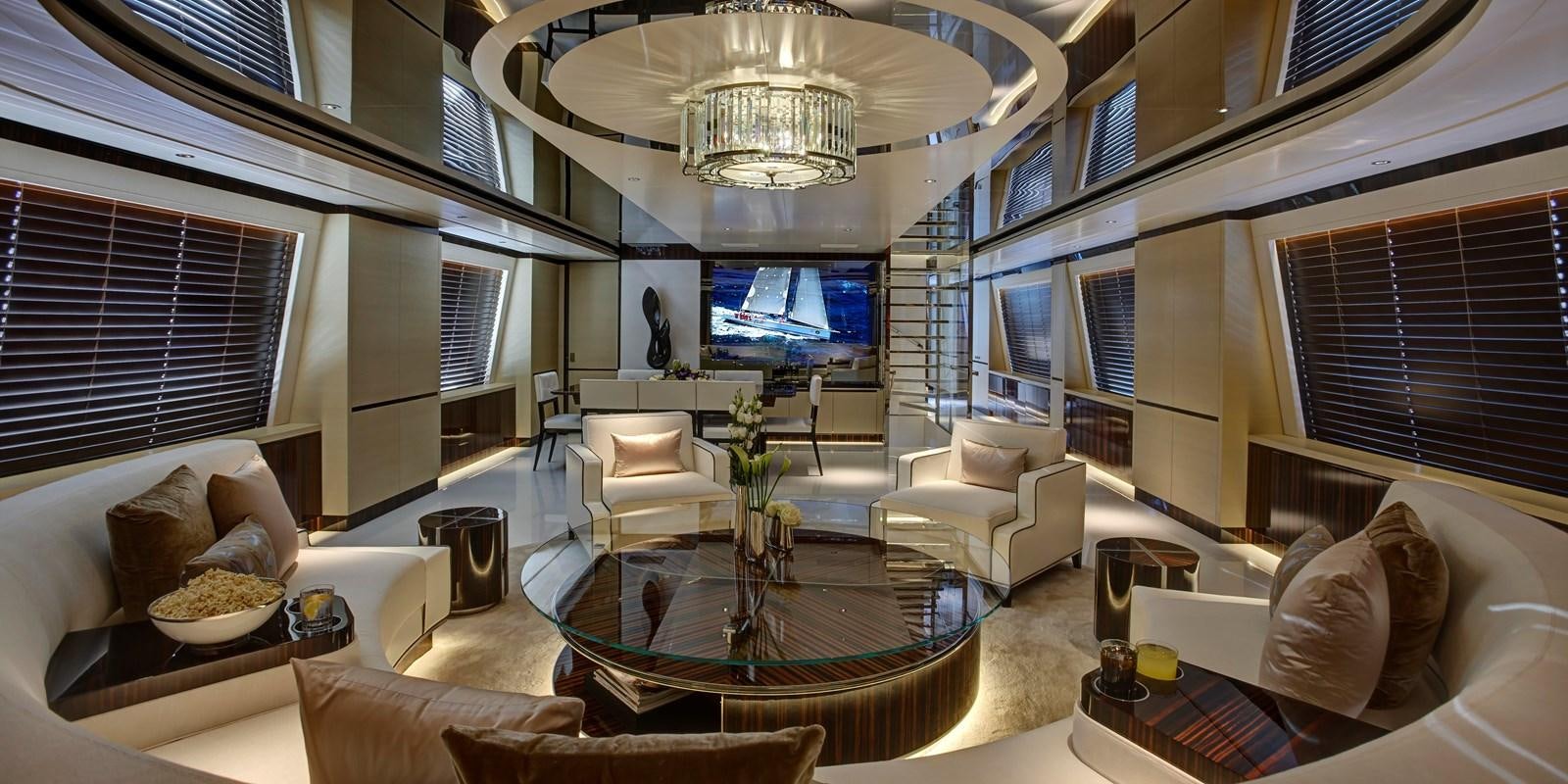 a living room with a large chandelier aboard EXCELLENCE V Yacht for Sale