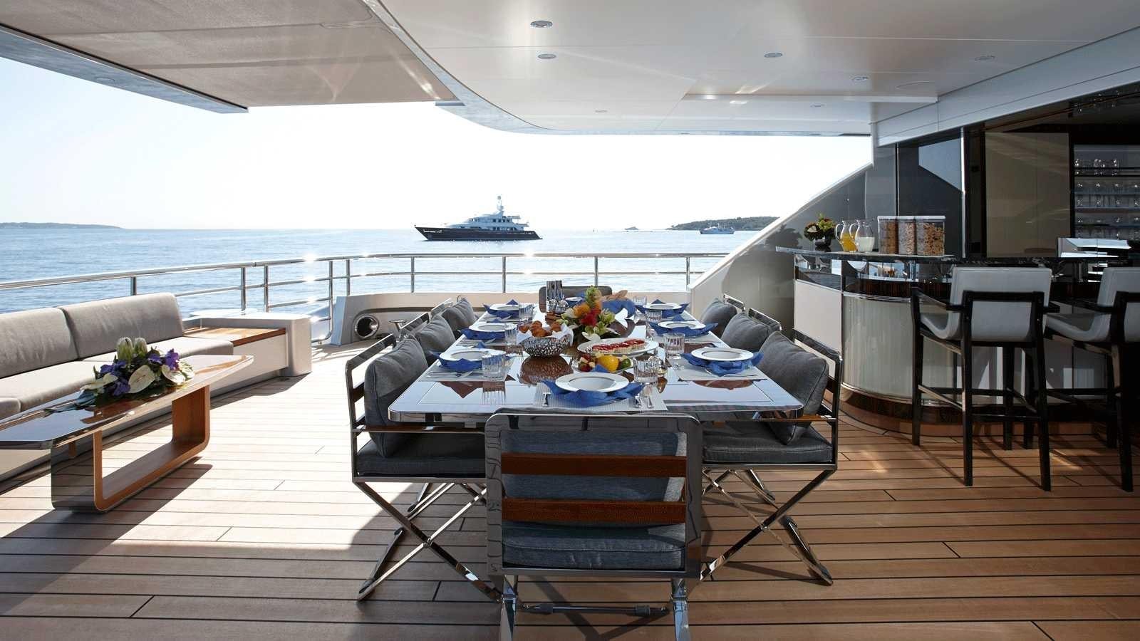 a room with a table and chairs aboard EXCELLENCE V Yacht for Sale