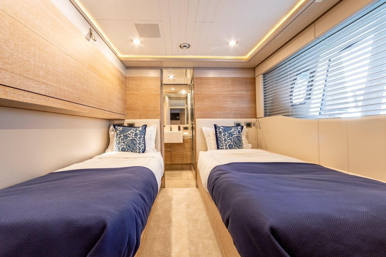 a room with beds and a window aboard CENTURION Yacht for Sale