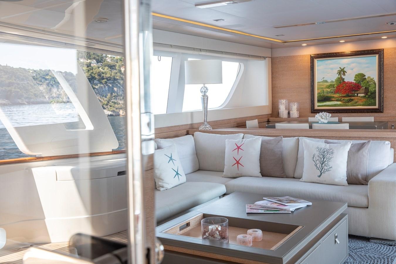 a living room with a couch and a table aboard CENTURION Yacht for Sale