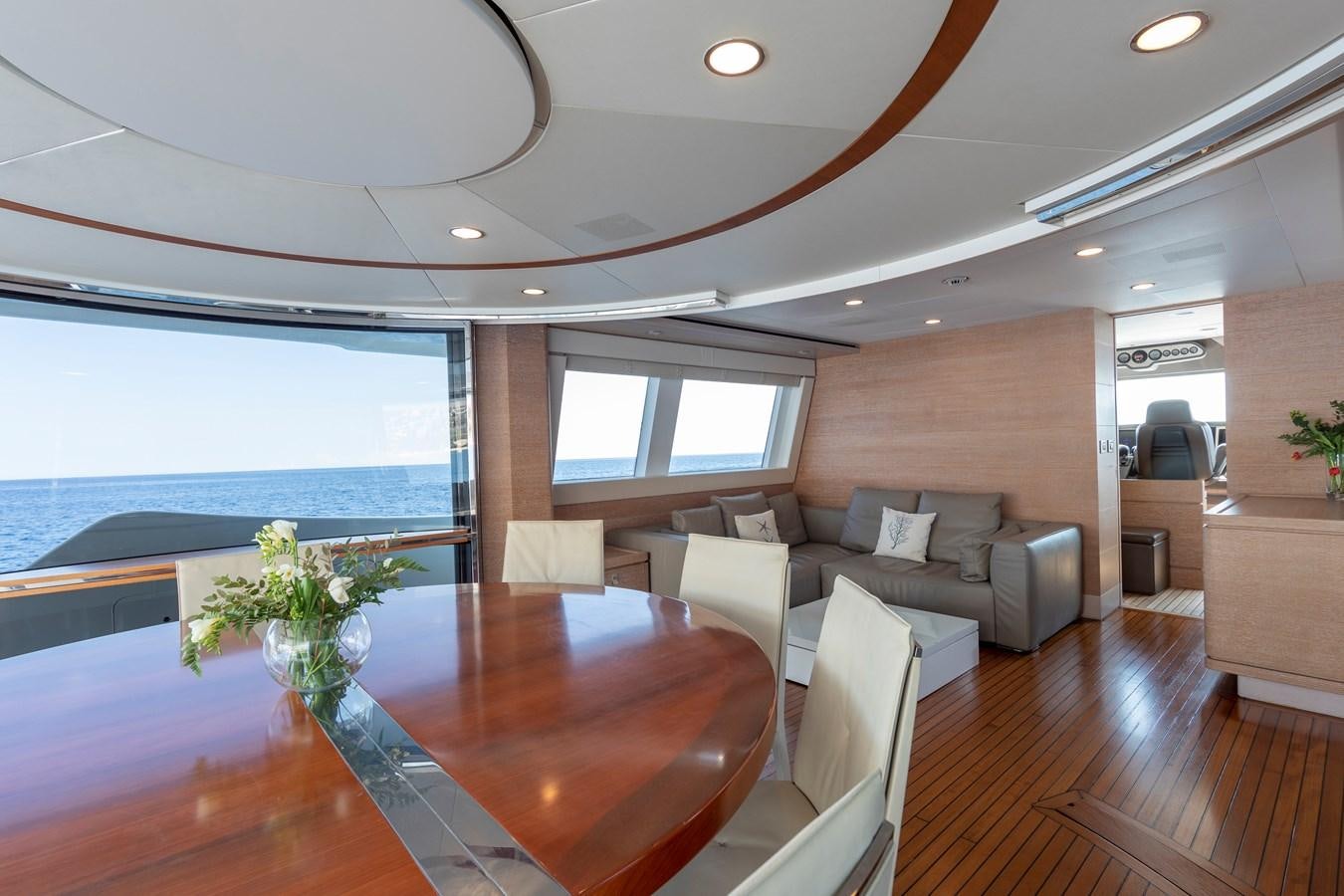 a living room with a table and couches aboard CENTURION Yacht for Sale