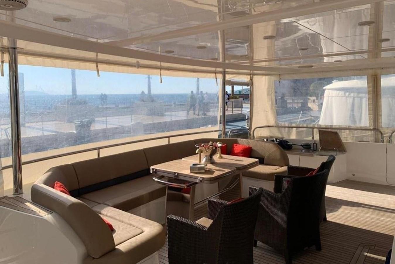a room with a couch and a table and chairs aboard PRINCESS 95 Yacht for Sale