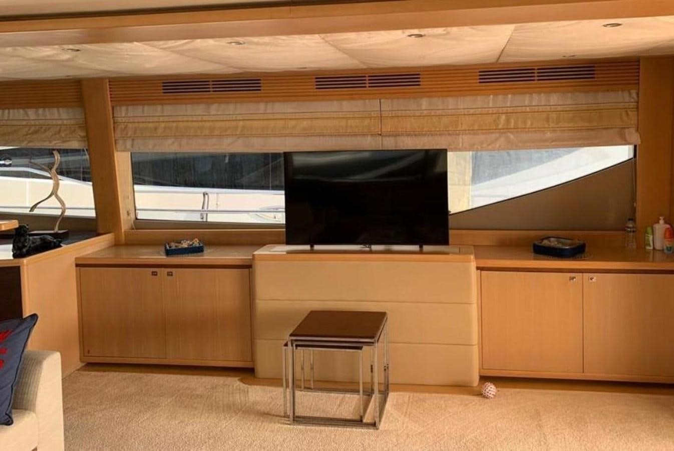 a room with a tv and a table aboard PRINCESS 95 Yacht for Sale