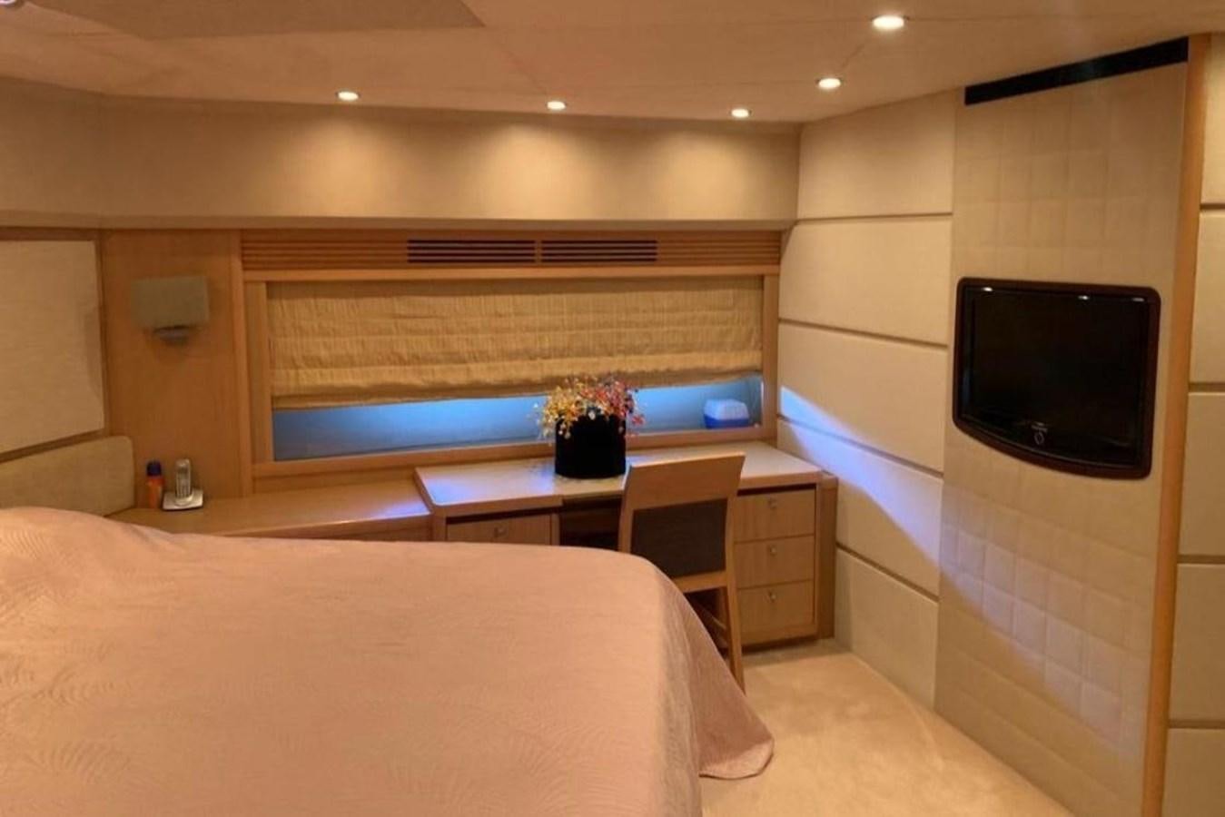 a room with a bed and a tv aboard PRINCESS 95 Yacht for Sale